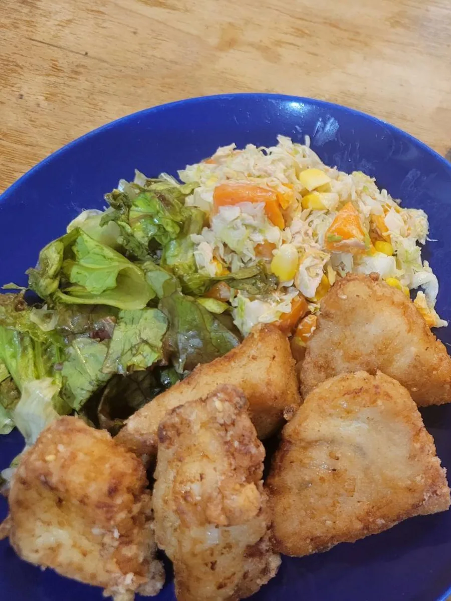 A table set with deep-fried marlin karaage and salad